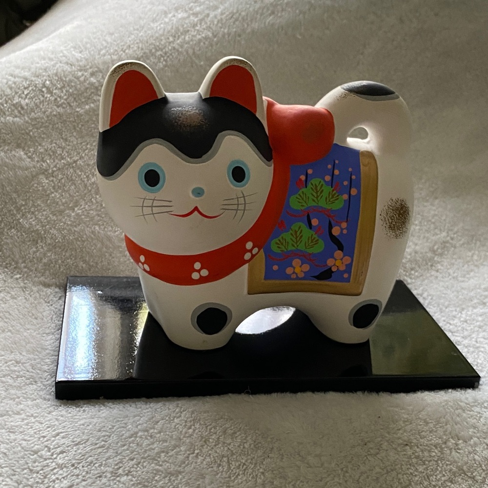 Whimsical Cat Figurine with Red and Black Details
